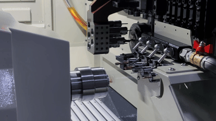 Automated unloading of a parallel dual-spindle lathe